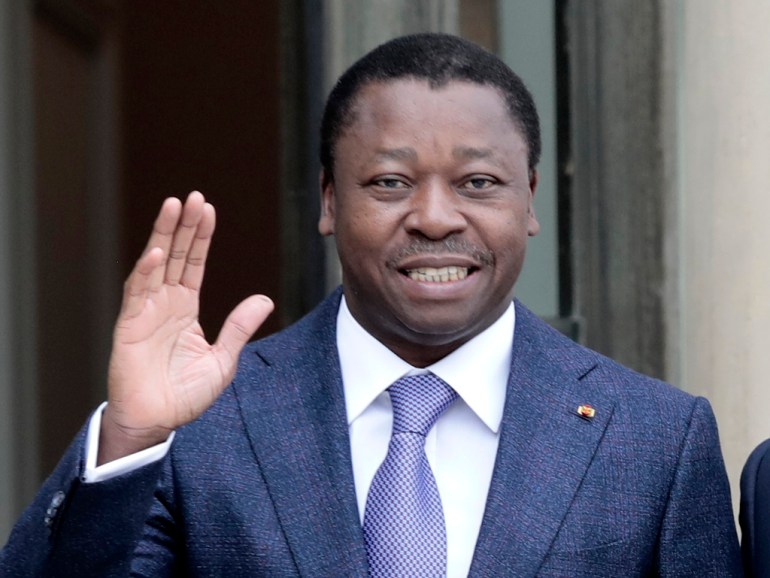 Togo's President Faure Gnassingbe waves before a working lunch at the Elysee Palace in Paris
