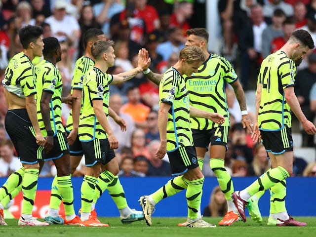 Arsenal's Leandro Trossard celebrates scoring their first goal with Ben White and teammates on May 12, 2024