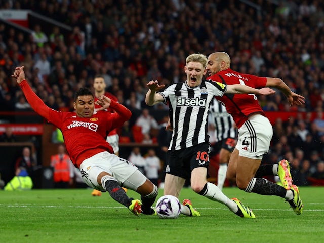 Newcastle United's Anthony Gordon in action with Manchester United's Casemiro and Sofyan Amrabat on May 15, 2024