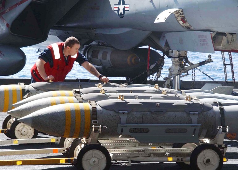 Ordnanceman assigned to the ship's G2 division moves 2000pound bombs 