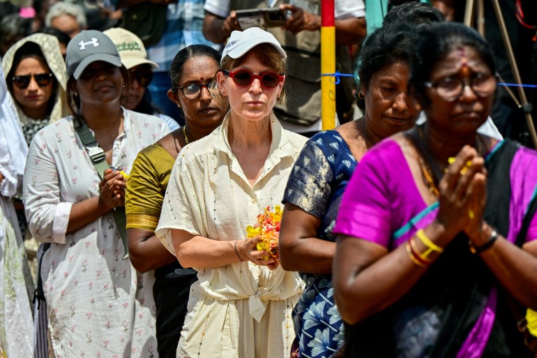 Amnesty International's global chief and Secretary General Agnes Callamard (3R) attends a commemoration ceremony at Mullivaikkal village in northern Sri Lanka on May 18, 2024 to remember victims of the country's 37-year Tamil separatist war that claimed at least 100,000 lives 15 years ago. May 18 marks 15 years since the killing of the Tamil Tigers' charismatic but reclusive leader Velupillai Prabhakaran, who had led the separatist group in open rebellion against Sri Lankan forces since the 1970s. His death in the village of Mullivaikkal was the culmination of a lightning military offensive that killed at least 40,000 civilians in the final months of the fighting, according to UN estimates. (Photo by Ishara S. KODIKARA / AFP)