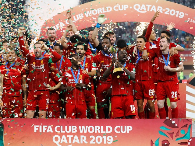 Liverpool's Jordan Henderson lifts the trophy as they celebrate after winning the Club World Cup on December 21, 2019