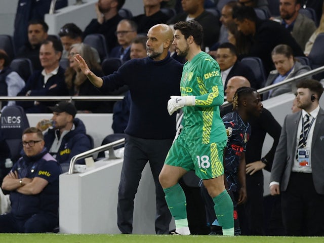 Manchester City's Stefan Ortega with manager Pep Guardiola before coming on as a substitute on May 14, 2024