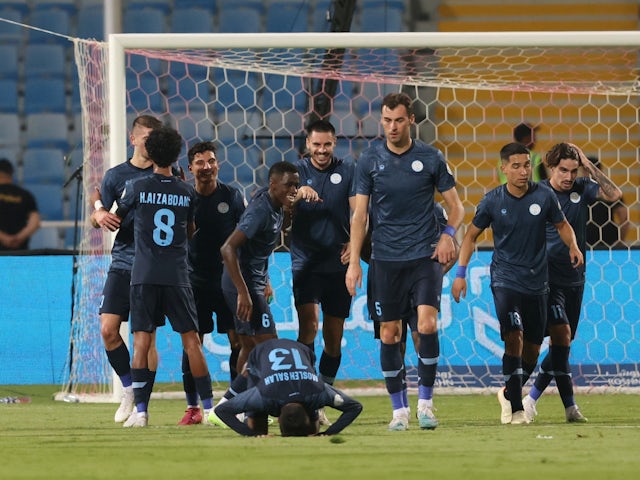 Al-Akhdoud's Andrei Burca celebrates scoring their first goal with teammates on August 14, 2023