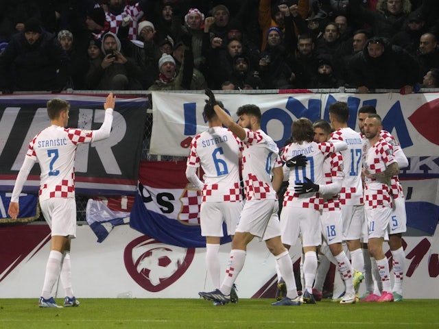 Croatia's Lovro Majer celebrates scoring their first goal with teammates on November 18, 2023