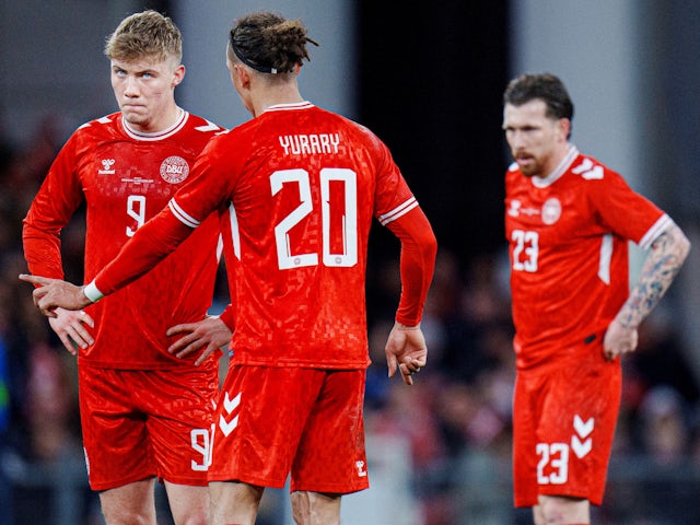 Denmark's Yussuf Poulsen speaks to Rasmus Hoejlund as Pierre Emile Hoejbjerg looks on on March 23, 2024