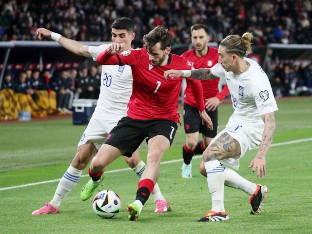 Georgia's Khvicha Kvaratskhelia in action with Greece's Kostas Tsimikas on March 26, 2024