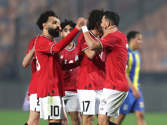 Egypt's Trezeguet celebrates scoring their first goal with Mohamed Salah and teammates on January 7, 2024