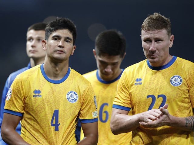 Kazakhstan's Marat Bystrov and Aleksandr Marochkin look dejected after the match on March 21, 2024