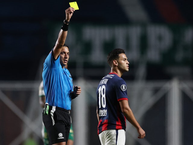 Cristian Ferreira of San Lorenzo is cautioned in an April 2024 Copa Libertadores encounter