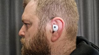 SteelSeries Arctis GameBuds in a man's ear