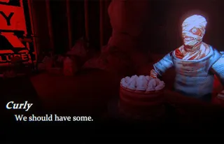 A bloodied and bandaged Curly sits at a table next to a cake. His speech reads: