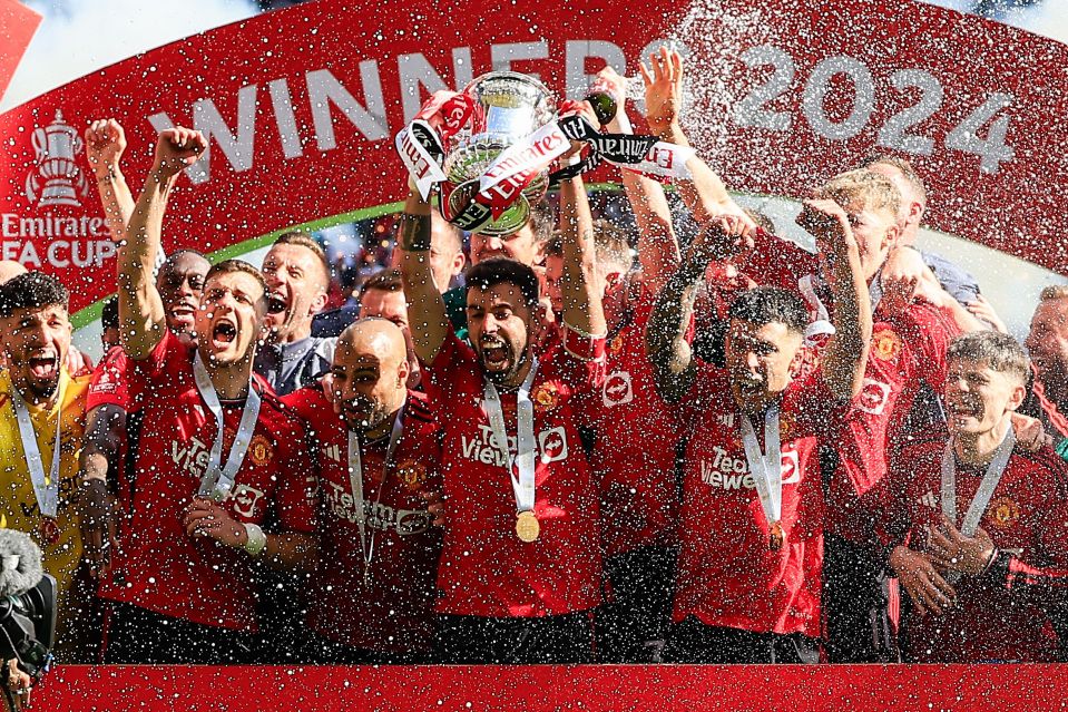 Bruno Fernandes lifts the FA Cup trophy after Manchester United beat rivals Manchester City.