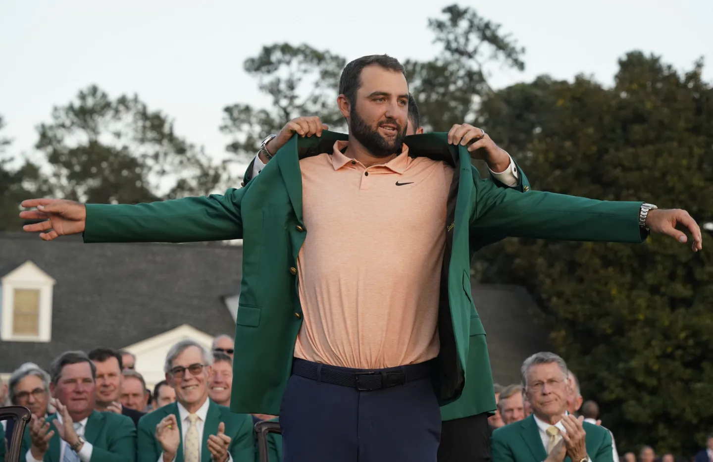 Scottie Scheffler of the United States puts on the green jacket during the awarding ceremony for the 2024 Masters golf tournament at Augusta National Golf Club in Augusta, Georgia, the United States on April 14, 2024.