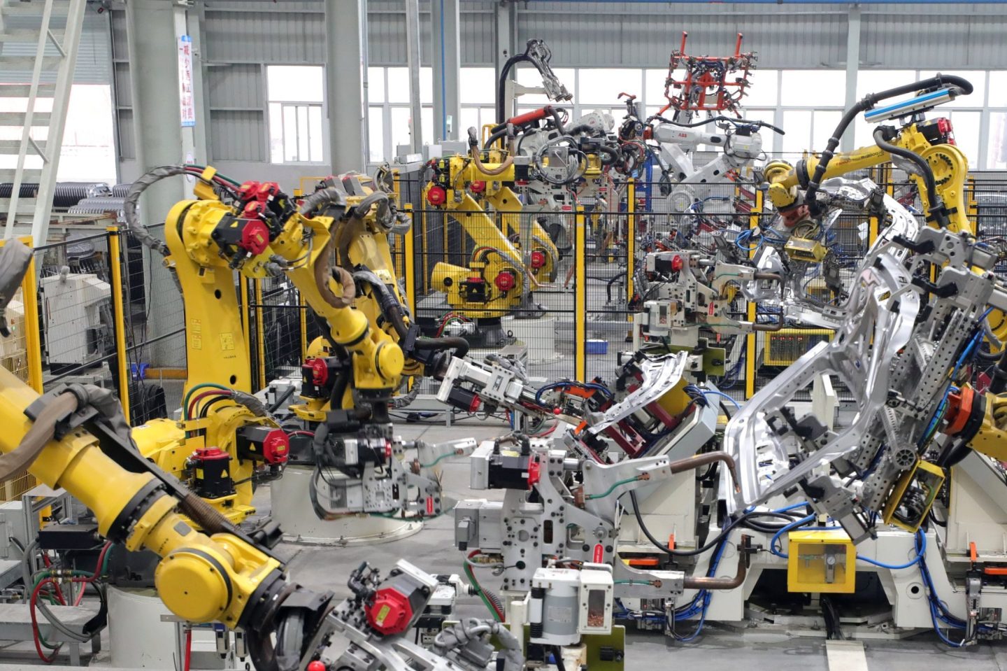 Smart robotic arms work on the production line at the production workshop of Changqing Auto Parts Co., LTD., located in Anqing Economic Development Zone, Anhui Province, China, on March 13, 2025.