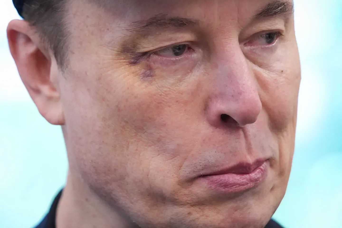Tesla CEO Elon Musk listens as U.S. President Donald Trump speaks to reporters in the Oval Office of the White House on May 30, 2025 in Washington, DC. Musk, who served as an adviser to Trump and led the Department of Government Efficiency, announced he would leave his role the Trump administration to refocus on his businesses.