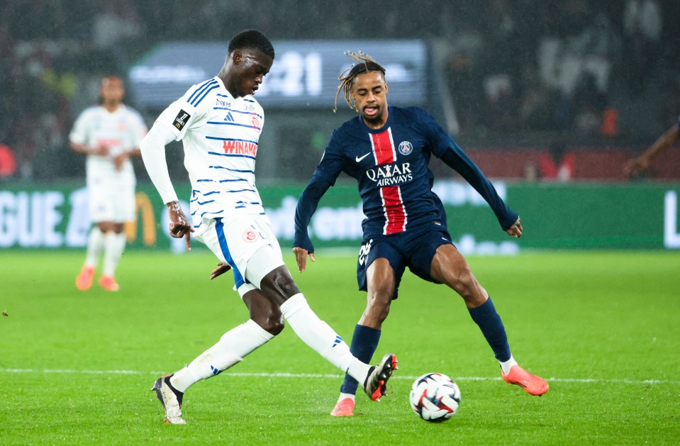 Soccer players Mamadou Sarr and Bradley Barcola competing on the field.