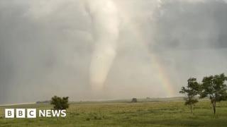 ‘Spectacular’ moment an enormous tornado crosses a rainbow