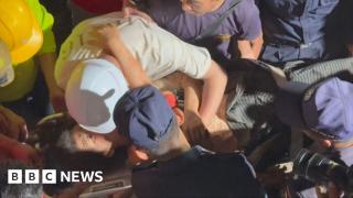 Moment rescuers pull woman alive from rubble