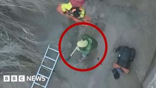 The hiker said he thought the ground was solid before his leg sank into the muck, trapping him until a rescue team arrived