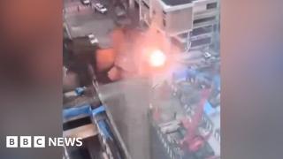 Moment sinkhole pulls down power lines in busy Bangkok street